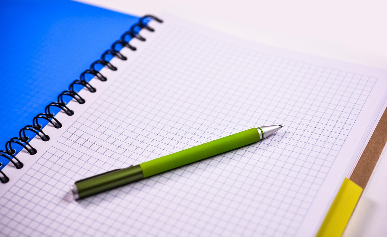 Notebook and pen on a desk, representing process documentation and planning